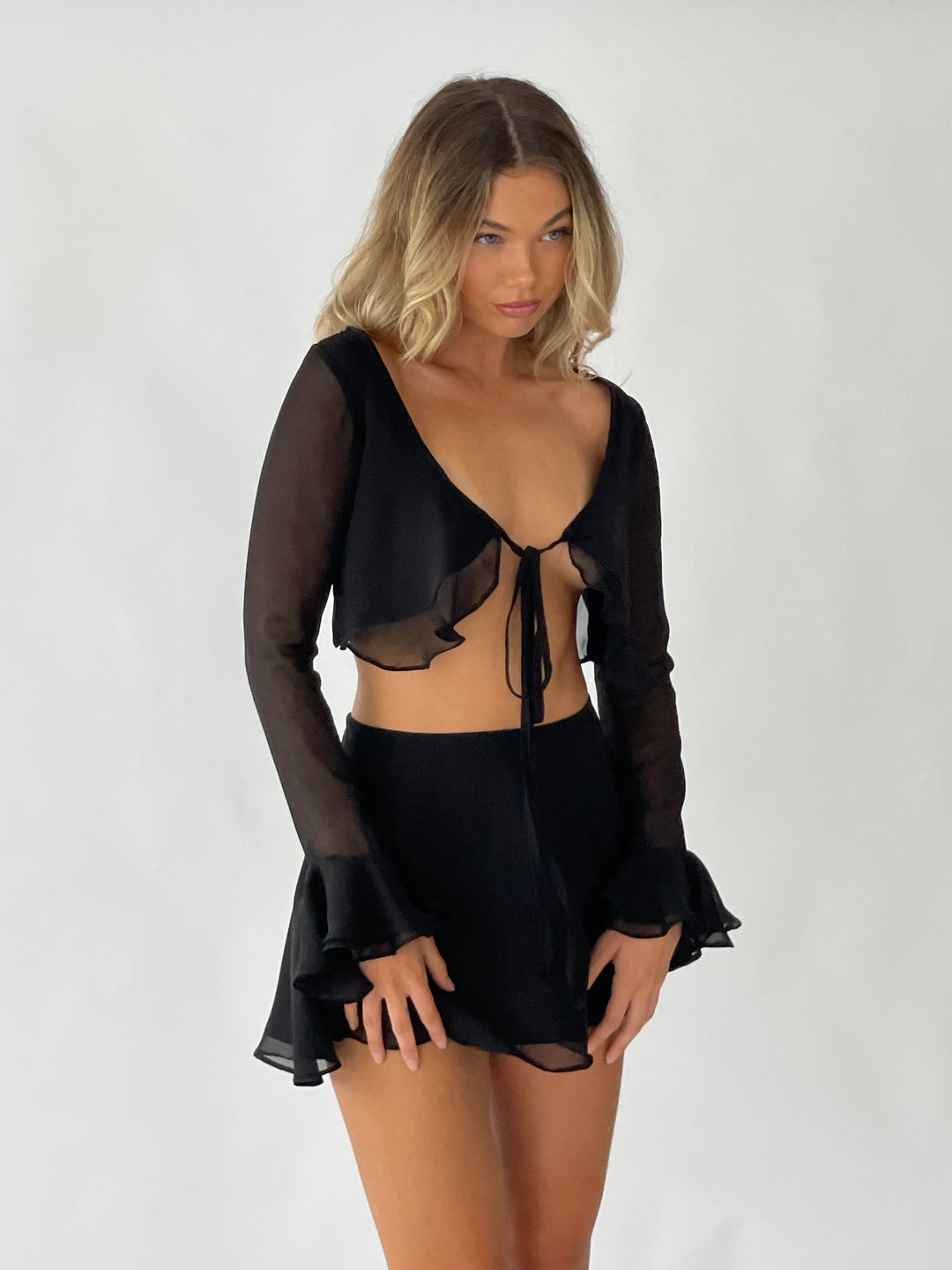 Silk cami sheer top front- top is black and has a lined (non-sheer)front with double frill sleeves. Skirt is skater style.