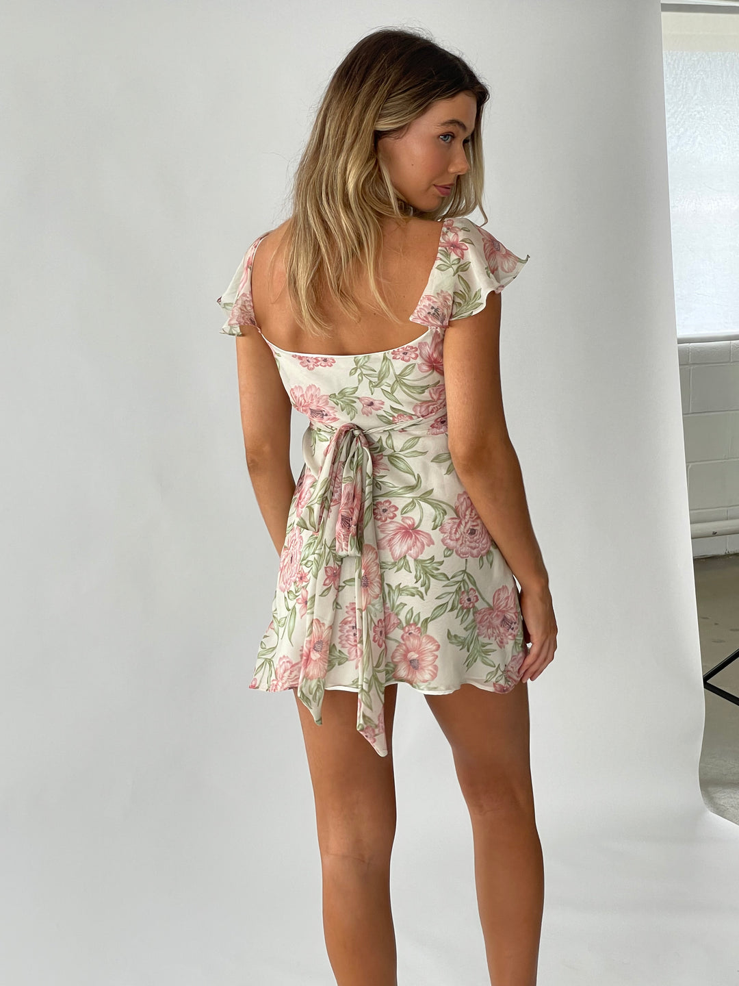 Floral silk mini dress back- vintage inspired floral print. Dress is lined in a silk and features a tie up back to pull in all the right areas. 